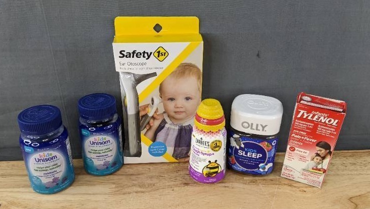 lot 143K image: Brand New Child Health and Wellness Items Unisom Melatonin Gummies, Zarabees Cough Syrup, Infants Tylenol, Olly Melatonin Gummies, and Safety 1st  Ear Otoscope $85 Retail W