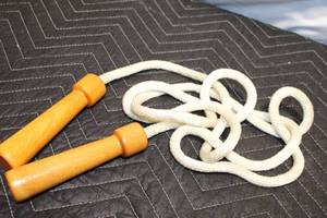 lot 37 image: Vintage Wooden Handled Jump Rope with Braided Cord