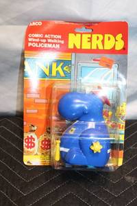 lot 85 image: Comic Action Wind-up Walking Policeman Toy by Arco
