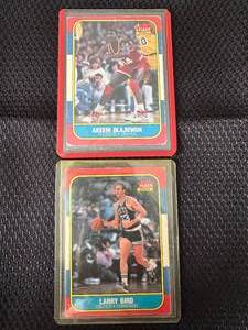 lot 2 image: LOT of (2) Olajuwon & Bird 1986 Fleer