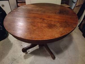lot 40 image: Solid Wood Round Dining Table on Wheels