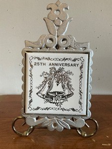 lot 101 image: Two 25th Anniverssary Trivets