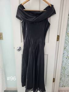 lot 96 image: Two Vintage Elegant Black Dresses One Off-Shoulder Dress and One Long Sleeve