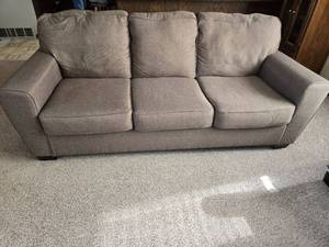 lot 3 image: Three-Cushion Fabric Sofa in Warm Grey by Ashley Furniture Industries