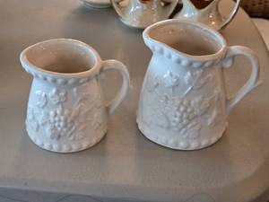 lot 147 image: Pair of White Embossed Porcelain Measuring Cup Creamers with Grape Vine Design