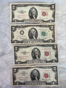 lot 62 image: LOT OF 3 RED SEAL $2 DOLLAR BILLS AND 1 1976 $2 DOLLAR BILL