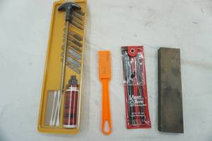 lot 31 image: gun cleaning kit and sharpening stone