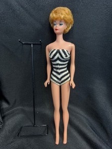 lot 24 image: VINTAGE PLATINUM BUBBLE CUT BARBIE WITH STAND AND SWIMSUIT STOCK NO. 850