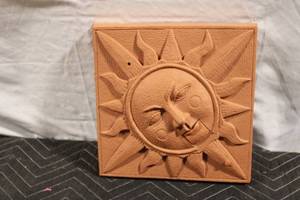 lot 252 image: Ceramic Sun Face Wall Art with Battery Operated Sound Feature
