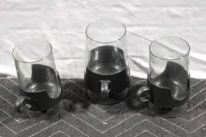 lot 312 image: Set of 3 Modern Glass Mugs with Black Holders