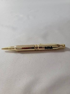 lot 98 image: NRA 308 Winchester Shell - Bullet Style Pencil.  &nbspClip of pencil is a rifle.