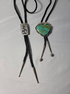 lot 95 image: 2 Leather Bolo Sterling Silver . One with unique design and one with turquoise center