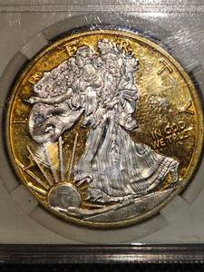 lot 121 image: 2014 Silver Eagle W Clad Silver, (24kt Gold Plated)