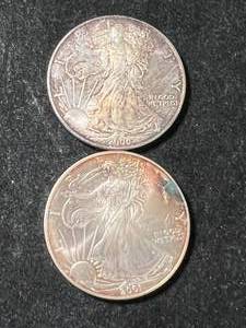 lot 60 image: 2 TONED AMERICAN SILVER EAGLES 1 TROY OZ .999 FINE SILVER EACH