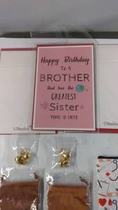 lot 122 image: Assorted Gifts Birthday Card, Custom Pouch, Blue Tumbler, and Karaoke Speaker