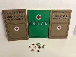 lot 168 image: Red Cross First Aid and Safety Booklets with Vintage Red Cross Pins