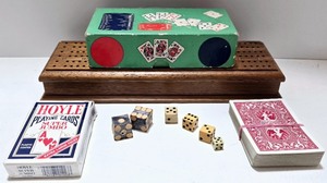 lot 77 image: Vintage Game Night Set with Cribbage Board, Playing Cards, and Dice