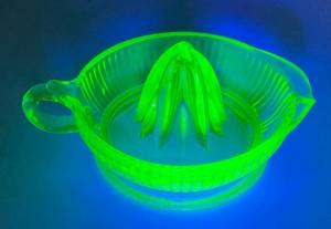 lot 229 image: Vintage Green Vaseline Uraium Glass Juicer Side Pour (Glows Under Black Light) Chip On Top Pour Spout