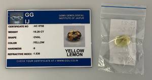 lot 293 image: GG IJ Gems Gemological Institute Of Jaipur 15.20 CT Oval Yellow Lemon With ID Card