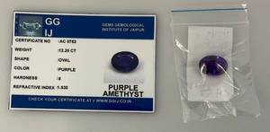lot 295 image: GG IJ Gems Gemological Institute Of Jaipuur 12.25 CT Oval Purple Amethyst With ID Card