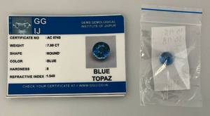 lot 296 image: GG IJ Gems Gemological Institute Of Jaipuur 7.90 Round Blue Topaz With ID Card