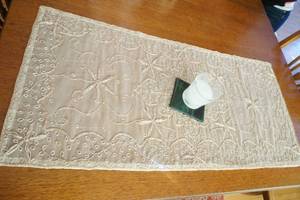 lot 25 image: embroidered table runner and candle