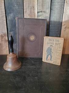 lot 66 image: Vingage Dick the Bank Boy Book, 1994 Wisconsin Badger Junior Class Book, Vintage Brass Bell with Wooden Handle