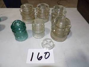6 GLASS INSULATORS THERE IS ONE SMALL CHIP IN 3 OF THEM