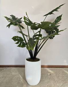 lot 155 image: Decorative Faux Monstera Plant in Modern White Planter