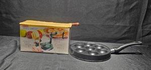 lot 127 image: Peel Away Apple & Potato Peeler and 7-Cup Cast Iron Pan