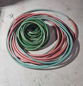 lot 134 image: Set of 2 Garden Hoses - Green and Red Rubber Reinforced Hoses