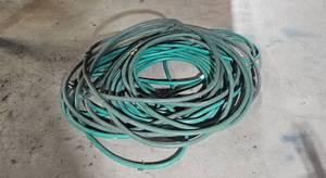 lot 136 image: Large Bundle of Green Garden Hoses