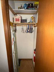lot 402 image: Closet Lot with Board Games, Light Bulbs, Hangers and Ironing Board