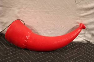 lot 190 image: Vintage Red Plastic Blow Horn with Leather Strap