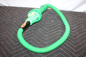 lot 199 image: Vintage Green Snake-Themed Toy Vacuum Attachment