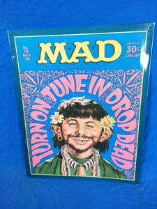 lot 38 image: Tin Wall Hanging Mad Magazine Cover April 1968,   Alfred E. Newman as a Flower Child