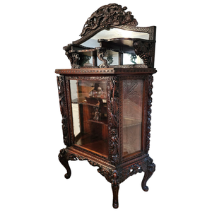 lot 5 image: Johnny Cash Owned  Ornately Carved Dragon Motif Curio Cabinet from His Master Bedroom $10,000 - $20,000 Estimate