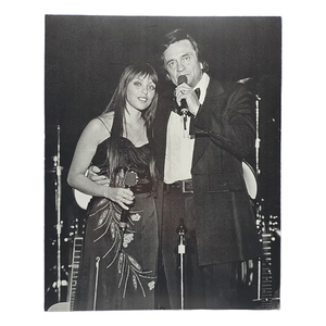 lot 174 image: Black and White Photograph of Johnny Cash and Daughter Cindy Cash on Stage
