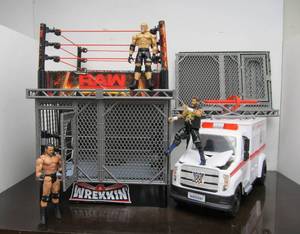 lot 9 image: Awesome Lot of Wrestling Action Figures wAmbulance & Cage Match Ring