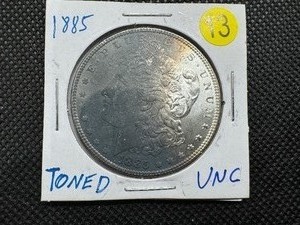 lot 13 image: 1885 Toned Morgan Silver Dollar UNC