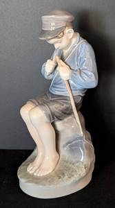 lot 107 image: Royal Copenhagen Boy Whittling a Stick Porcelain Figurine  Royal Copenhagen Figurine 905