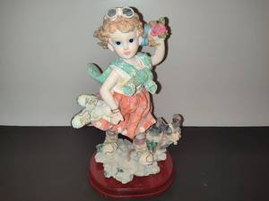 lot 122 image: Vintage Flocked Figurine Featuring Girl Carrying Skates wDog