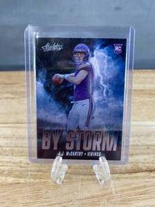 lot 136 image: 2024 Panini Absolute JJ McCarthy By Storm RC #BS-JMY T
