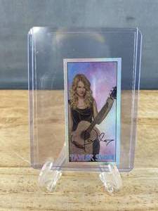 lot 209 image: Taylor Swift with Guitar Mini Chrome Tobacco Sweet Caporal Cigarettes Card J