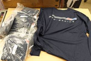 lot 275 image: 10 Amsoil Racing Medium and Small Long Sleeve Shirts