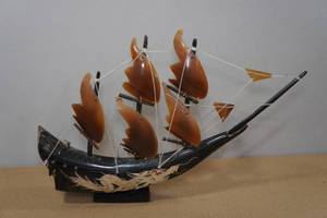 lot 163 image: Hand Carved Buffalo Horn Ship Statue