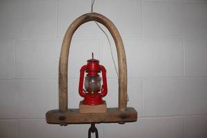 lot A-80 image: Vintage Red Lantern Hanging on Rustic Wooden Yoke Decor
