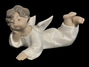 lot 52 image: Lladro Porcelain Angel Laying Down Figurine
