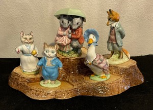lot 68 image: Beatrice Potter Figurines with Royal Doulton Display Stand