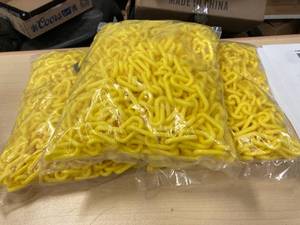 lot 57 image: 3-50 foot packages of yellow plastic chain for crowd controlsafety barrieror parking